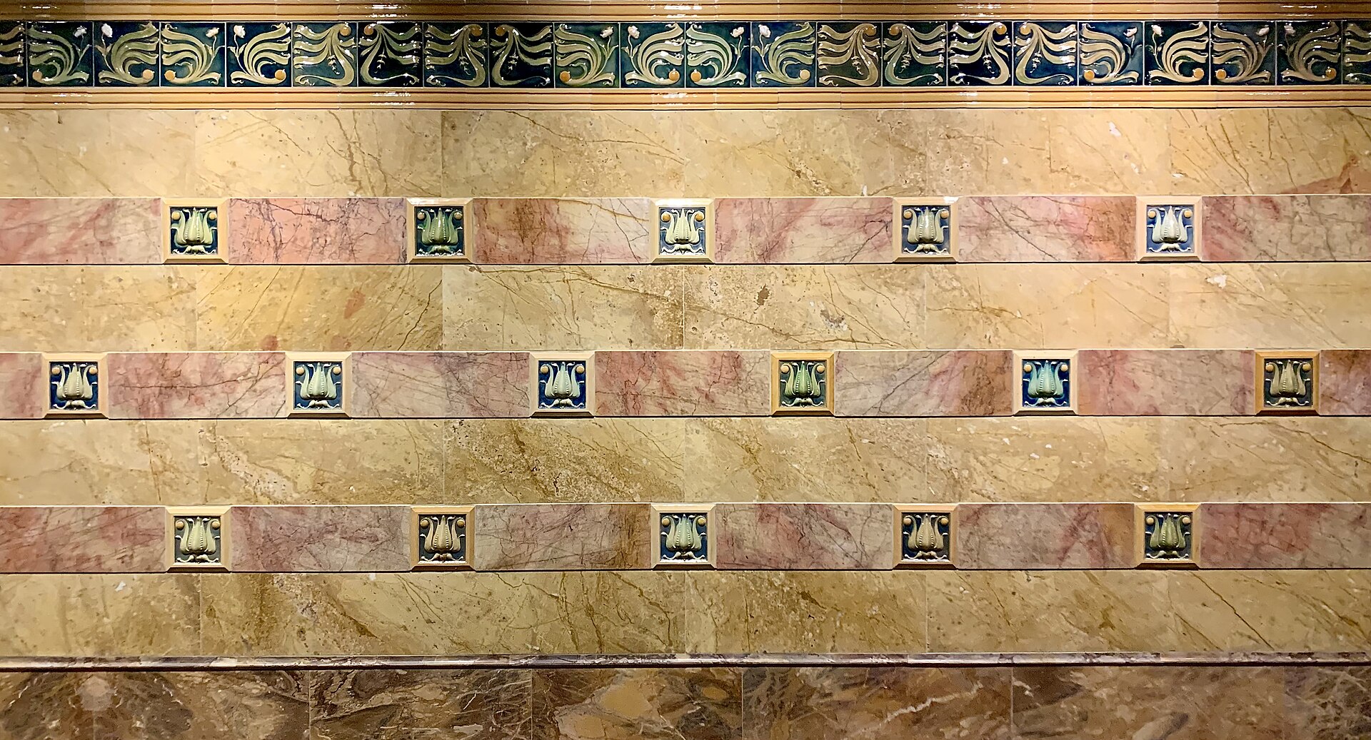 An Art Nouveau ceramic and marble wall installation by Alban Chambon, on display in the Fin-de-Siecle Museum