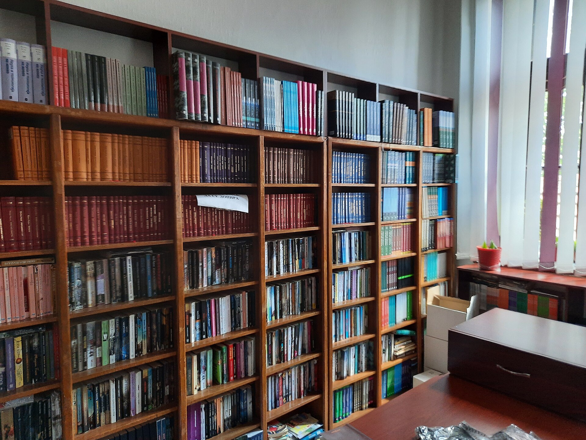 Wooden shelving lined with books in the Resen City Library reading room, inside the Saraj