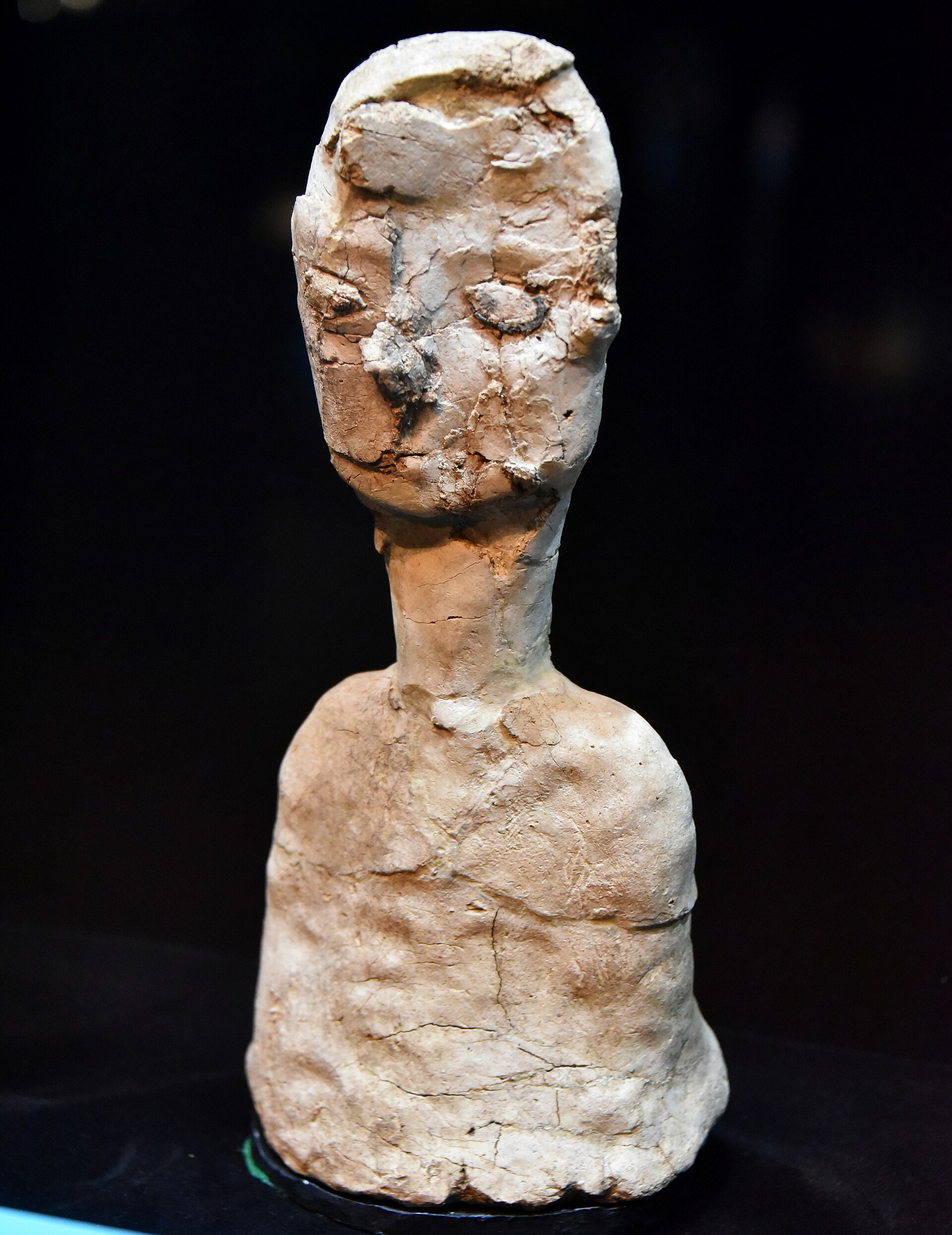 A lime-plaster human statue from Ain Ghazal on display at The Jordan Museum