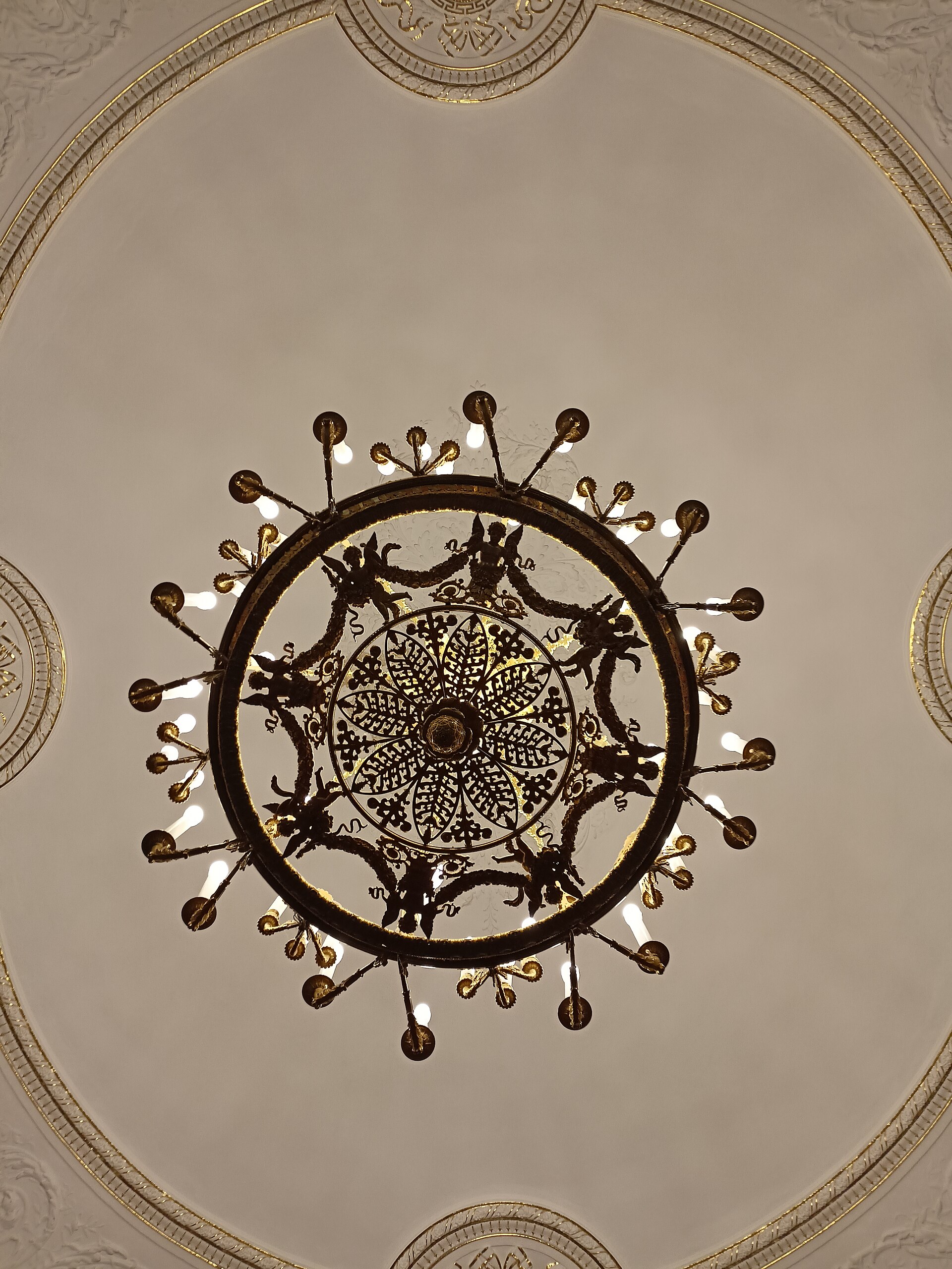 A gilded ceiling and chandelier inside the Mikhailovsky Palace