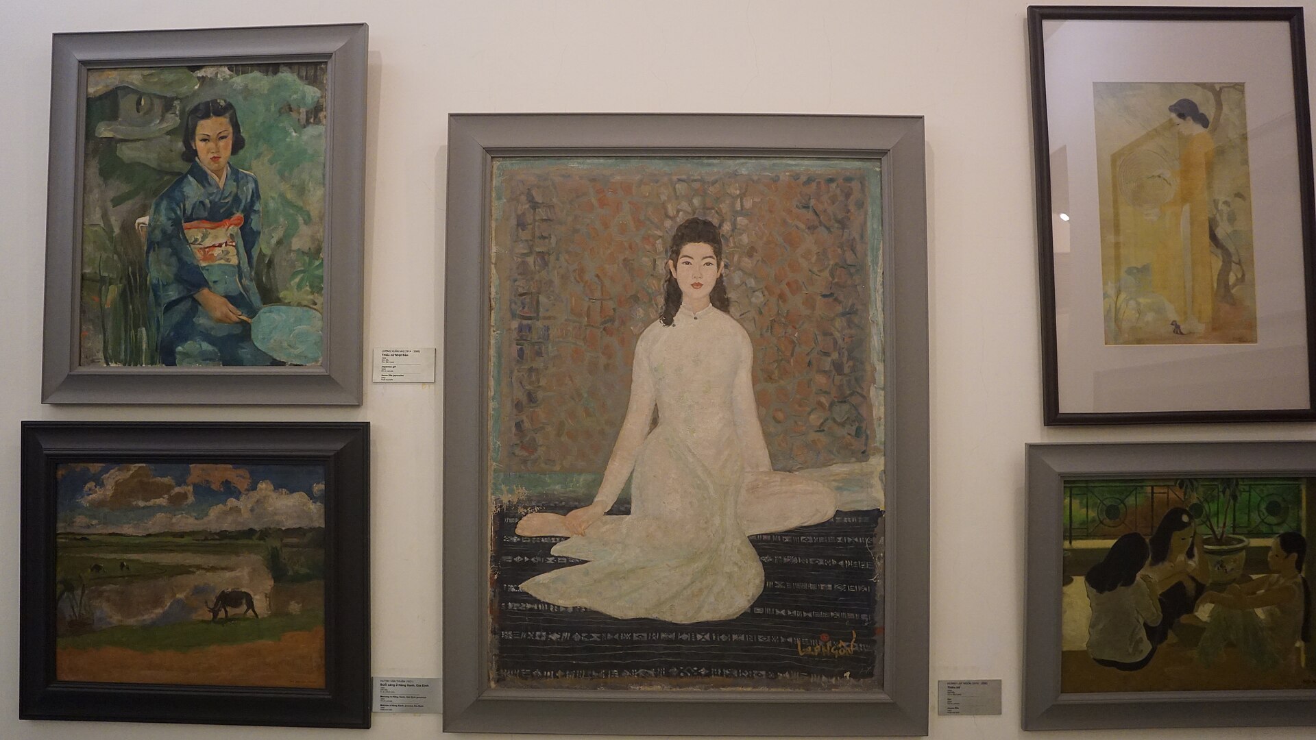 Framed paintings hung on a gallery wall inside the Vietnam National Museum of Fine Arts
